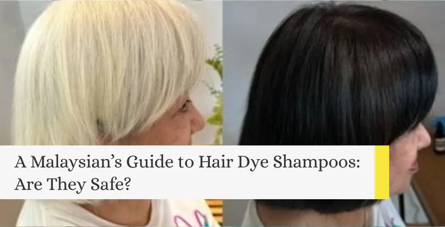 A smiling young Asian woman lathering hair dye shampoo into her hair inside a bright, modern bathroom.