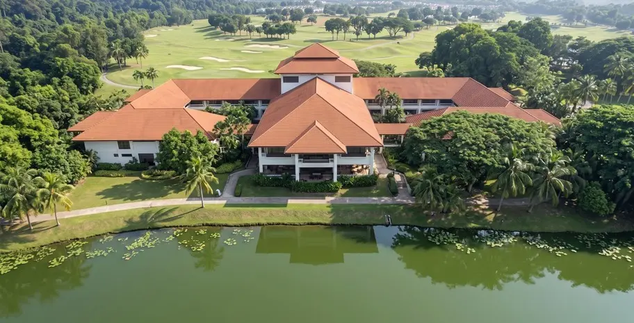 Aerial view of a low-rise resort hotel set among tropical rain trees, lakes and golf fairways in the Klang Valley